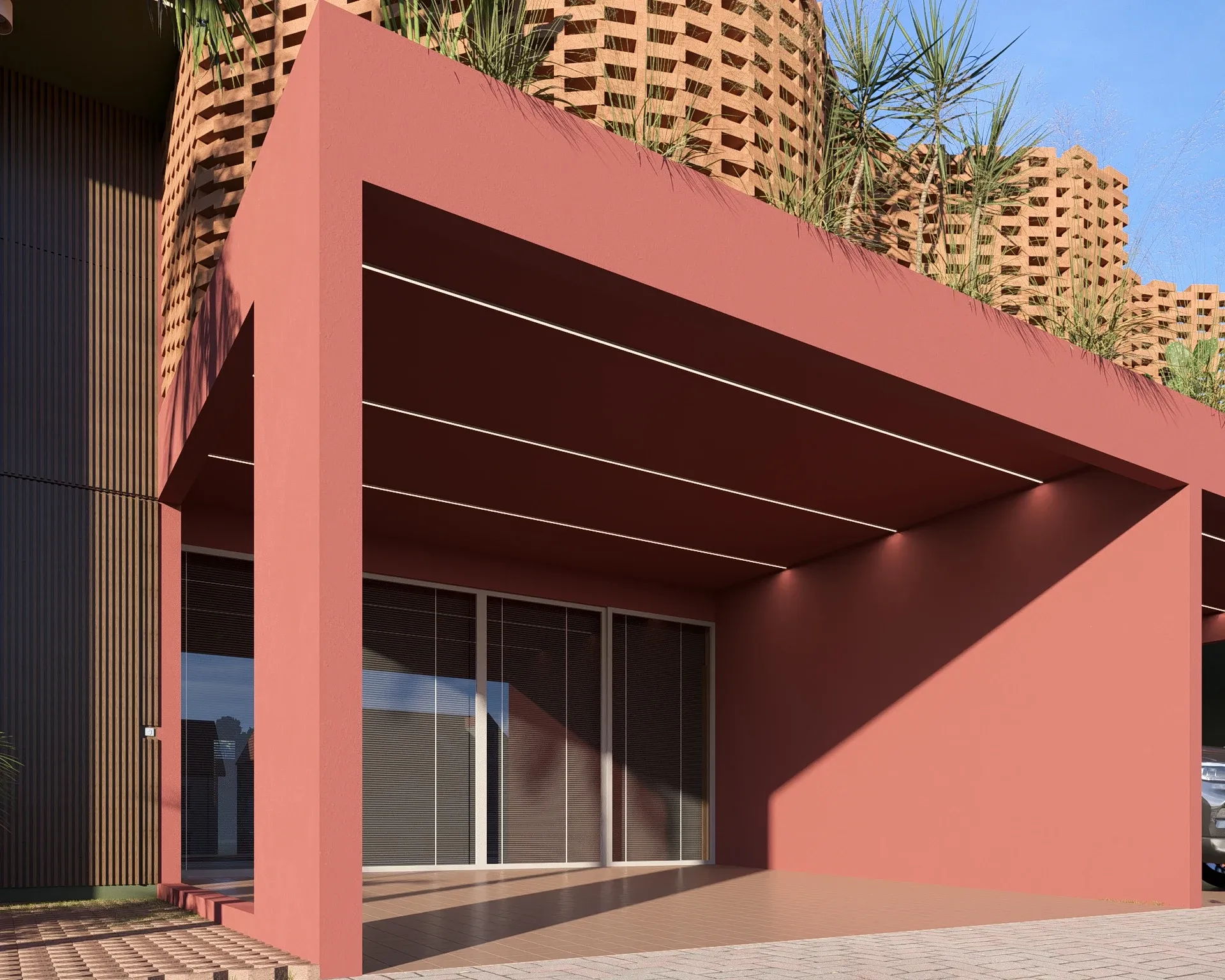 Entrada e garagem com pórtico contemporâneo em tom terracota sob volume superior orgânico com cobogó curvo ondulante em tijolo cerâmico vazado e vegetação tropical